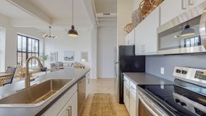 Schenectady apartment for rent - an open kitchen with stainless steel appliances and white cabinets