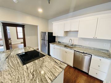 Albany apartment for rent - a kitchen with white cabinets and stainless steel appliances
