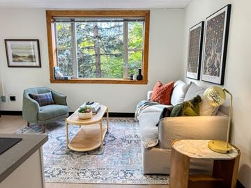 Troy apartment for rent - A living room with a couch, chair, and a table with a lamp.
