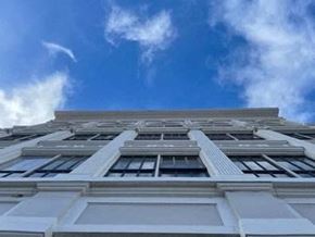 Schenectady apartment for rent - a tall white building with the sky in the background