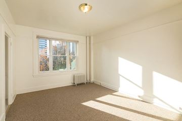 Seattle apartment for rent - a living room with a window and a carpet