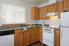 Seattle apartment for rent - a kitchen with white appliances and wooden cabinets