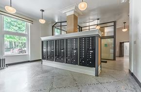 Seattle apartment for rent - A large, modern, black and white control panel in a spacious room with tiled flooring and large windows.