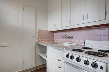 Seattle apartment for rent - A kitchen with a white stove and white cabinets.
