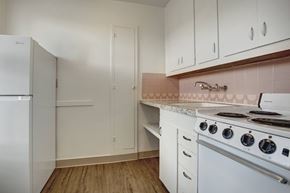 Seattle apartment for rent - A kitchen with white appliances and cabinets.