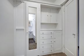 Seattle apartment for rent - A white cabinet with drawers is open to a bedroom.