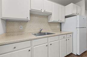 Seattle apartment for rent - A kitchen with white cabinets and a sink.