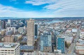 Seattle apartment for rent - A cityscape with a mix of modern and older buildings under a clear sky.