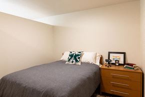 Seattle apartment for rent - a small bedroom with a bed and a dresser at Arbora Court, Washington, 98105
