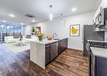 Philadelphia apartment for rent - A kitchen with a white countertop and a white couch in the background.