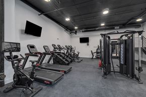 Philadelphia apartment for rent - A gym with treadmills, exercise bikes, and a weight rack.