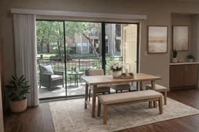 Houston apartment for rent - A dining room with a table and chairs and a view of a backyard.