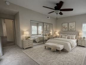 Houston apartment for rent - A bedroom with two beds, a dresser, and a ceiling fan.