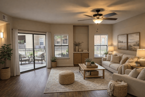 Houston apartment for rent - A well-lit living room with a ceiling fan and a large window.