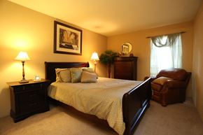 Houston apartment for rent - a bedroom with a bed and a chair