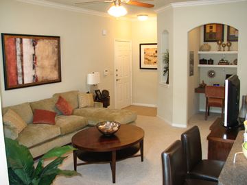 Houston apartment for rent - A living room with a couch, chair, and a painting on the wall.