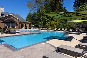 Indianapolis apartment for rent - A large swimming pool with a building in the background.
