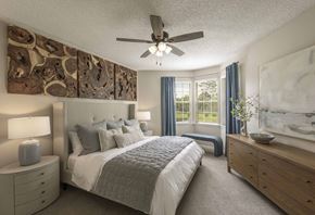Longwood apartment for rent - A bedroom with a bed, dresser, and ceiling fan.