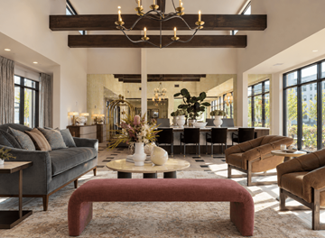 Louisville apartment for rent - A modern living room with a large couch, a coffee table, and a chandelier.