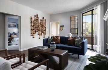 Indianapolis apartment for rent - A living room with a blue couch and a wooden coffee table.
