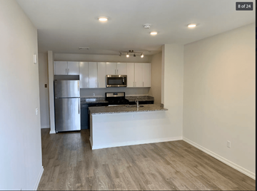 Norwalk apartment for rent - A kitchen with a refrigerator, microwave, and a countertop.