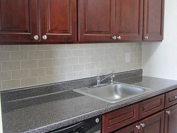 Hackensack apartment for rent - a kitchen counter with a sink and wooden cabinets