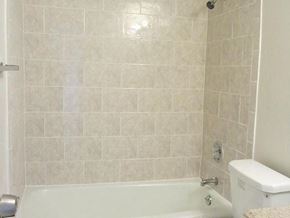 Hackensack apartment for rent - a bathroom with a white tub and a toilet