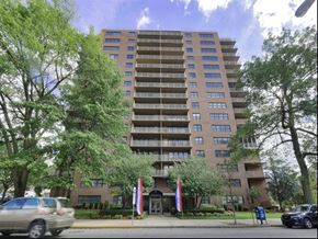 Passaic apartment for rent - an apartment building on the corner of a street with cars