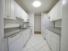 Passaic apartment for rent - a white kitchen with white appliances and white cabinets