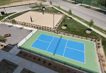 A tennis court with a green and blue surface