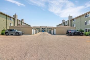 Parking lot with garage units and apartment buildings