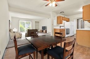 Davenport apartment for rent - A dining room with a wooden table and chairs. at Winding Hills Apartments, Iowa