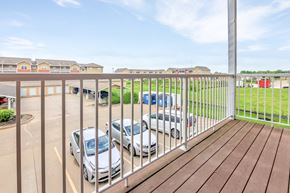 Silvis apartment for rent - A parking lot with cars and apartment buildings in the background. at Deer Valley Apartments, Silvis, 61282