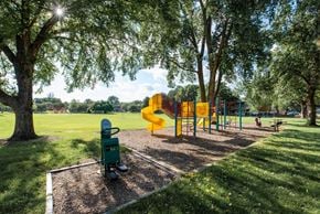 Falcon Heights apartment for rent - A playground with a yellow slide and a green toy chest.