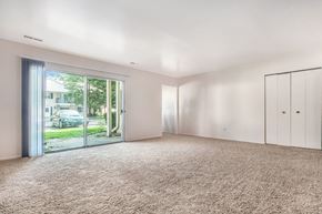 Elkhart apartment for rent - an empty living room with white walls and a sliding glass door