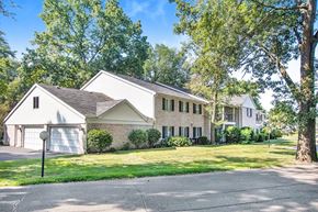 Elkhart apartment for rent - the front of a white house with a yard and trees