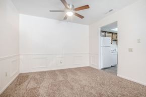 Bristol apartment for rent - A room with a ceiling fan and a refrigerator in the corner.