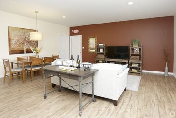 South Bend apartment for rent - A living room with a white couch and a television.