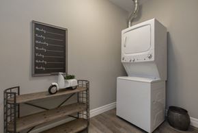 Kingston apartment for rent - A white oven is in a kitchen next to a shelf with a chalkboard on the wall.