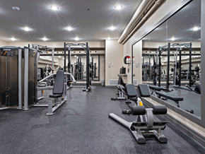 Kingston apartment for rent - a gym with weights and cardio equipment and a large glass wall