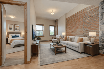 Kingston apartment for rent - A living room with a white couch and a brick wall.