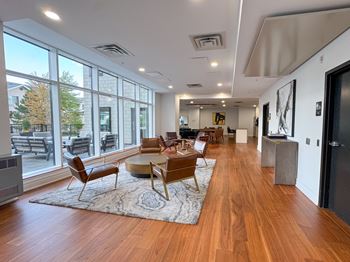 A spacious living room with wooden floors and furniture.