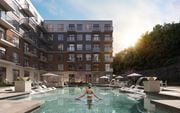 Kanata apartment for rent - A woman is swimming in a pool surrounded by apartment buildings at The Woods at 180 Kanata Avenue Apartments, Kanata, ON
