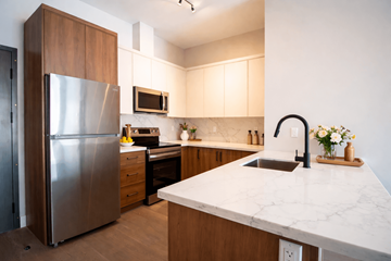 Kingston apartment for rent - A kitchen with a marble counter top and a refrigerator.