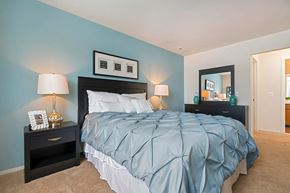 Clinton Township apartment for rent - a bedroom with a blue wall and a bed
