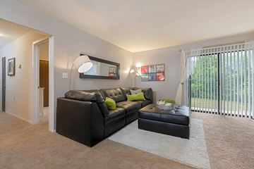 Clinton Township apartment for rent - a living room with a leather couch and a large window