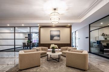 Ottawa apartment for rent - A modern living room with a large painting on the wall and a coffee table in the center.