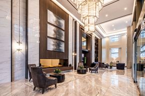 Ottawa apartment for rent - A spacious lobby with a marble floor and a large chandelier.