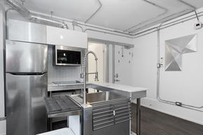 Ottawa apartment for rent - A modern kitchen with stainless steel appliances and a large island.