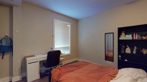Ottawa apartment for rent - a bedroom with a bed and a desk and a window